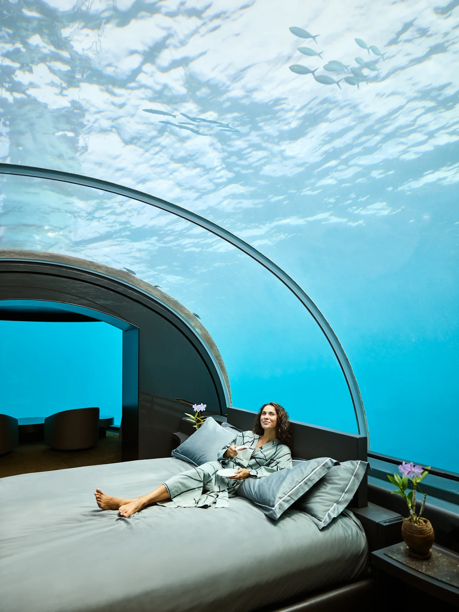 A private underwater suite bedroom beneath the reef